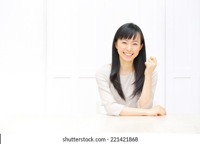 Attractive Asian Woman Relaxing In The All White Room