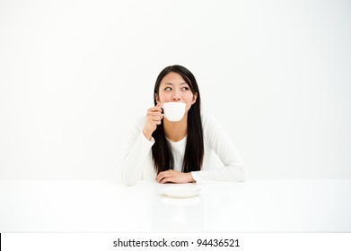 Attractive Asian Woman Relaxing In The All White Room