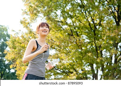 Attractive Asian Woman Running In The Park