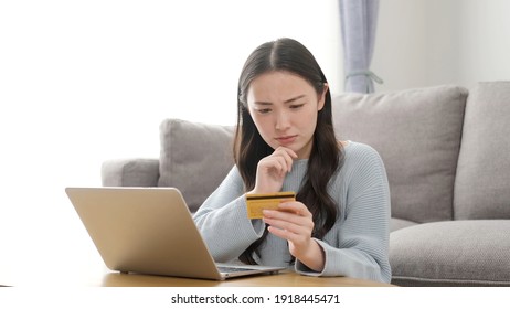 Attractive Asian Woman Shopping Online With A Credit Card