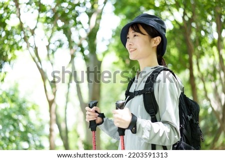 attractive asian woman trekking in forest