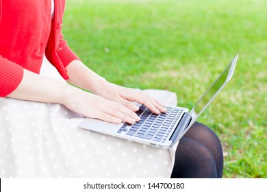 Attractive Asian Woman  Using Laptop In The Park