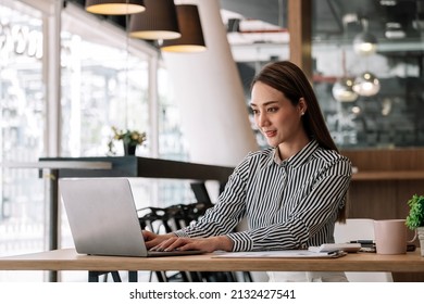 Attractive Asian Woman Using Laptop While Doing Homework Making Video Call Abroad Using Internet Friend Connection, Business Women Use Computer Analysis Finance Data