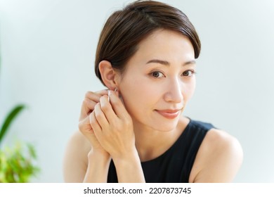 attractive asian woman wearing earring - Shutterstock ID 2207873745