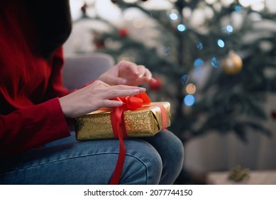 Attractive Asian Woman Wrapping A Gift Box Christmas And New Year's Festival, Background Christmas Tree.