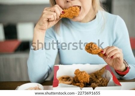 Attractive Asian women eating fried chicken
