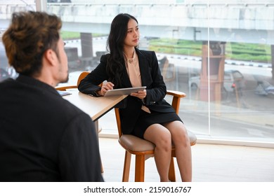 Attractive Asian young female business worker listened intently to her team's presentation in the meeting. - Shutterstock ID 2159016767