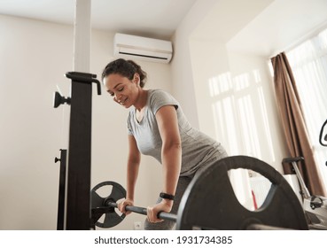 Attractive Athletic Woman Exercising Deadlift In A Home Gym. Concept Of Heavy Weight Training.