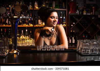 Attractive bartender with drinks