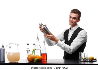 An Attractive Bartender With A Shaker At A Bar Counter, Lime, Oranges, Lemons Isolated On A White Background.