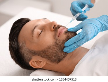 Attractive Bearded Man Visiting Aesthetic Clinic, Getting Lips Filler, Closeup. Middle Aged Businessman Having Beauty Injection At Male Spa Salon. Face Care, Anti-aging Treatment For Men Concept