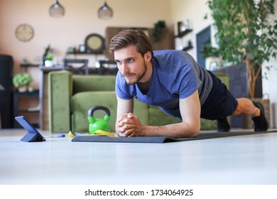 Attractive Beared Man Doing Plank Exercise At Home During Quarantine. Fitness Is The Key To Health.