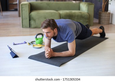 Attractive Beared Man Doing Plank Exercise At Home During Quarantine. Fitness Is The Key To Health.