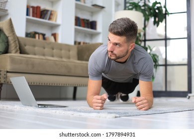 Attractive Beared Man Doing Plank Exercise At Home. Fitness Is The Key To Health.