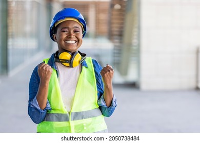 Attractive beautiful African American business woman engineer developer standing and hands up raised arms from happiness, Excited woman winner success concept - Shutterstock ID 2050738484