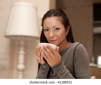 An attractive beautiful female holding a mug of coffee - Shutterstock ID 41188921