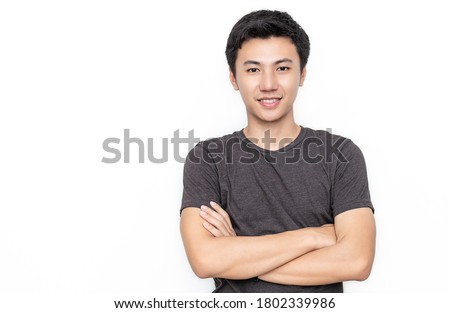 Attractive beautiful positive asian man - close up portrait of asian teenage man. Portrait of handsome nerd Japanese asia guy wearing t-shirt with big smile isolated on white background.