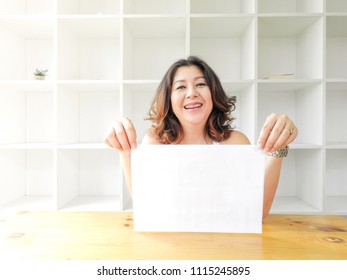 Attractive Beautiful Woman Holding Blank White Paper.