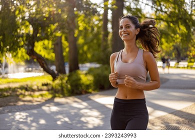 Attractive beautiful woman wearing sportswear running outdoors. Fit woman jogging outdoor. Workout exercise in the morning. Healthy and active lifestyle concept. - Powered by Shutterstock