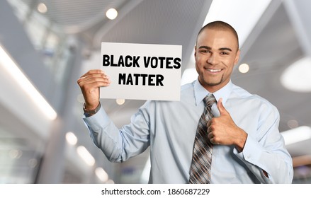 Attractive Black Activist Holding A Voter Suppression Sign