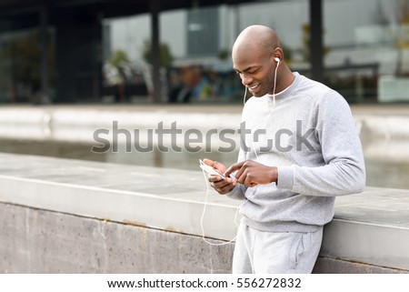 Similar – Attractive black man listening to music with earphones