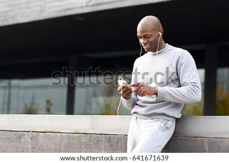 Similar – Attractive black man listening to music with earphones