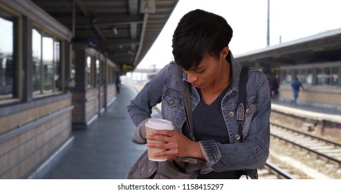 Attractive Black Woman Waiting For Train Digs Through Her Purse