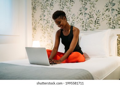 Attractive Black Woman Working With Her Laptop On Her Bed At Home