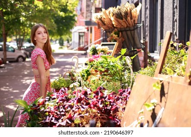 Attractive Blogger With Bright Makeup Near The Flower Shop Outside