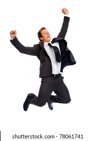 Attractive blond man celebrates by jumping raises his fist overhead
