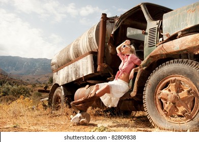 Attractive Blond Woman Near An Old Truck.