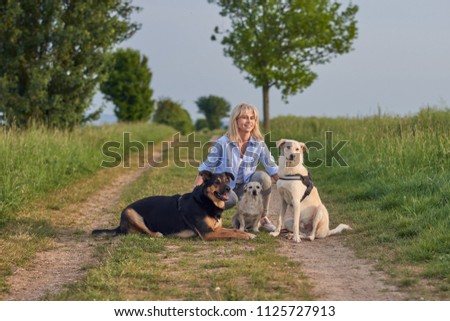 Similar – Attractive smiling blond woman with her two dogs