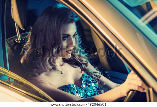 Attractive blonde beauty
in an elegant car