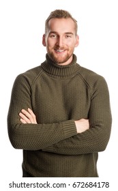 Attractive Blonde Man Standing Against A White Background Wearing A Green Turtle Neck Shirt Looking At Camera.