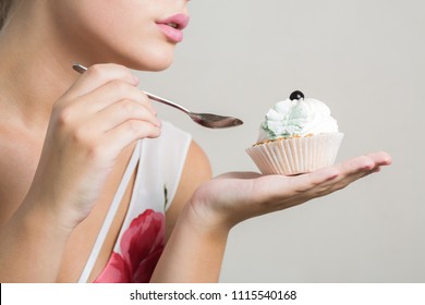 Attractive Blonde Model Eating Tasty Sweet Dessert With Butter Cream. Closeup Shot