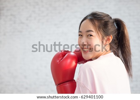 Attractive Boxing woman or beautiful woman wearing boxing gloves or mitt isolated on retro brick wall