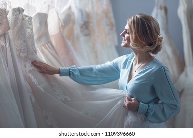 Attractive Bride Choosing A Wedding Dress In The Store