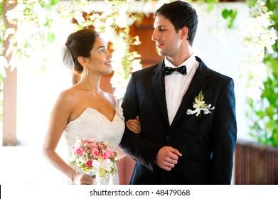 An Attractive Bride And Groom Getting Married Outdoors