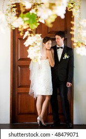 An Attractive Bride And Groom Getting Married Outdoors