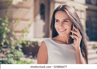 Attractive brunette businesswoman talking on mobile phone with client. - Powered by Shutterstock