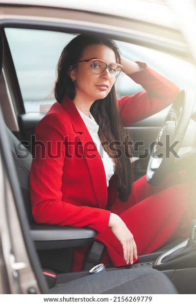 Attractive brunette in\
the car. Lady\
driving.