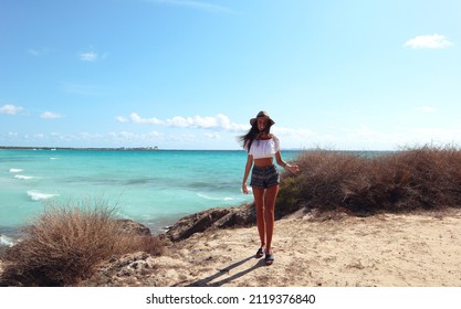 Attractive brunette with curly hair woman. Сheerful cute charming girl, Spain, Mallorca. Chill and comfort. Beautiful girl in a white shirt looks at the sea. Marine background. Relaxed atmosphere.  - Shutterstock ID 2119376840