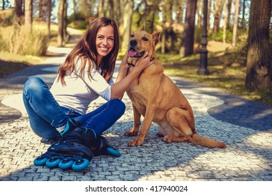 Attractive Brunette Female Posing With Her Dog On A Road In A Spring Nature Par.