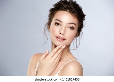 Attractive Brunette With Shiny Highlighters And Glossy Lips Touching Her Chin, Pretty Woman With Natural Mua And Perfect Hairstyle