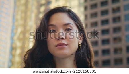 Young asian woman taking photo with her smartphone