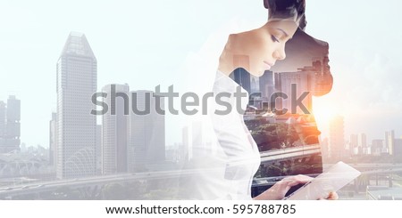 Attractive business lady working on tablet . Mixed media