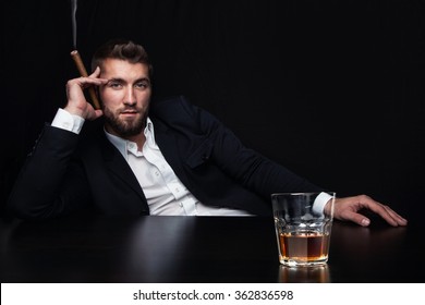 Attractive Business Man With A Cigar And A Glass Of Whiskey