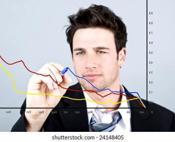 Attractive business man drawing on a graph
