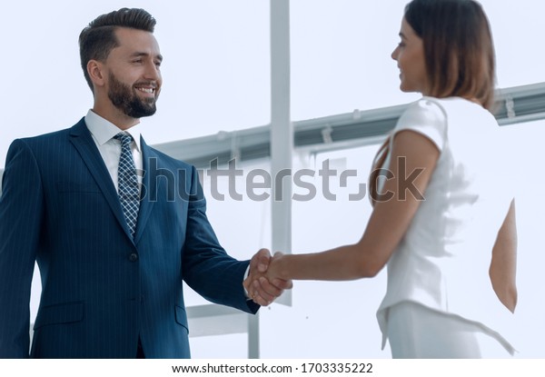 Un hombre de negocios atractivo y un equipo de mujeres estrechando la mano