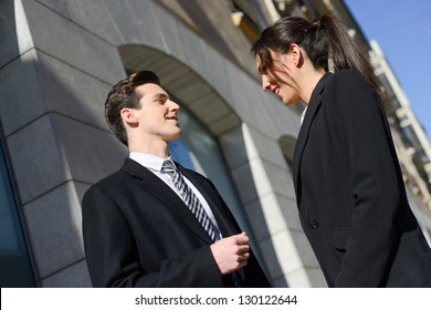 Attractive Business People Talking Outside Of Company Building. Couple Working.